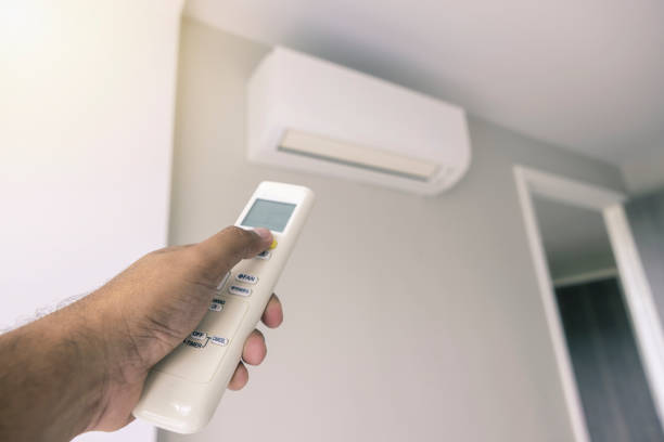 istock Control the air conditioner using the bedroom remote control on hot days 1387391457