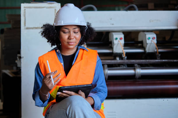 istock Female engineer worker quality control inspects by tablet at a paper factory. 1387397041