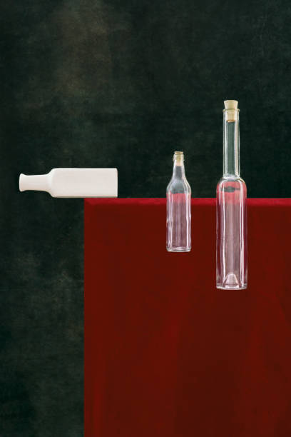 Abstract still life with bottles on the background of a red object