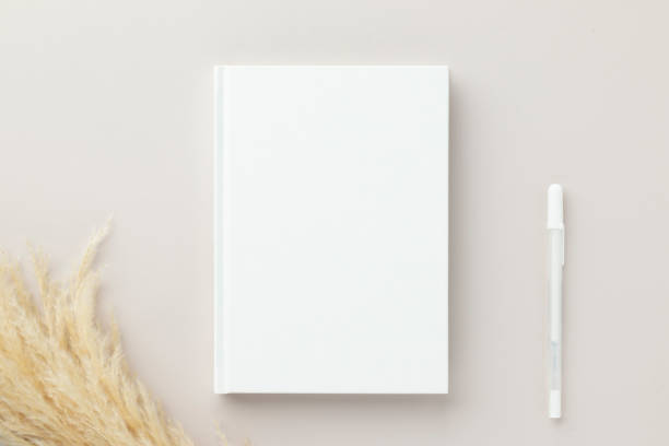 istock White book blank cover mockup on a beige background, flat lay, mockup 1387400895