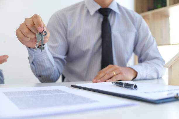 istock Sales manager giving advice application form document, considering mortgage loan offer for car and house insurance. 1387402331