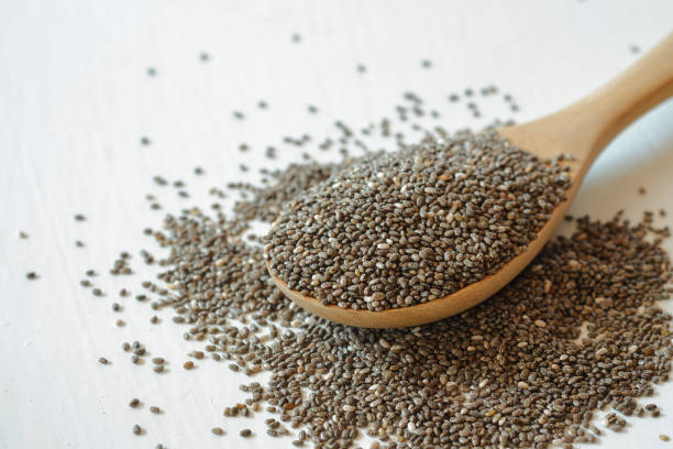 istock Chia seeds in a wooden spoon on a white background. 1387403154