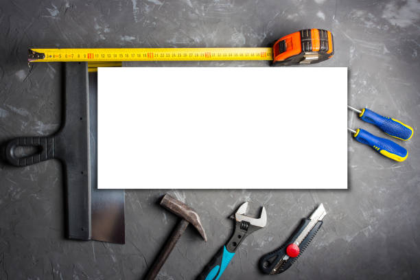 istock A mockup of construction tools against a background of dark concrete screwdriver, construction trowel, pliers, construction tape measure, hammer, office knife, adjustable wrench, template, construction repair 1387406234