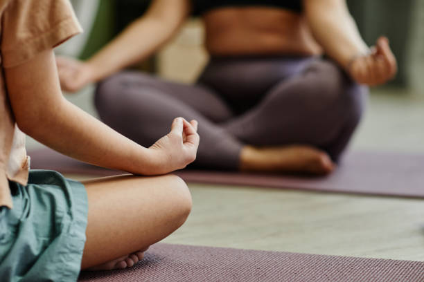 istock Mother and Daughter Meditating Closeup 1387407079
