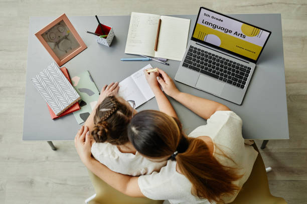 istock Girl with Down Syndrome Studying with Mom Top View 1387407096