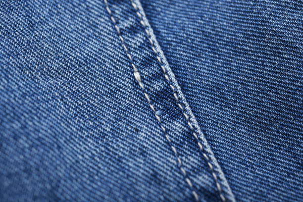 istock Old blue jeans background and texture close up.Denim seam. 1387408961