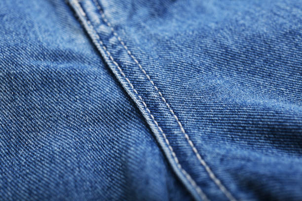 istock Old blue jeans background and texture close up.Denim seam. 1387408992