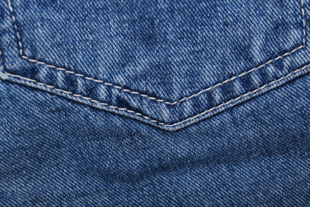 istock Old blue jeans background and texture close up.Denim seam. 1387409004