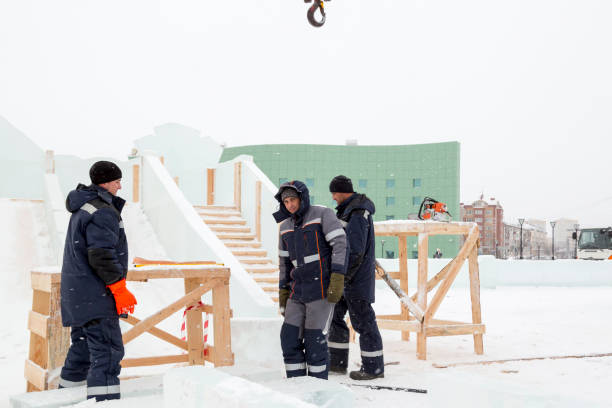 istock Workers are assembling ice blocks on the frame of a wooden slide 1387412417