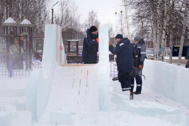 istock Workers are assembling ice blocks on the frame of a wooden slide 1387412433