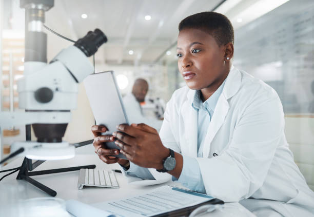 istock Shot of a young scientist using a digital tablet while working in a lab 1387412453