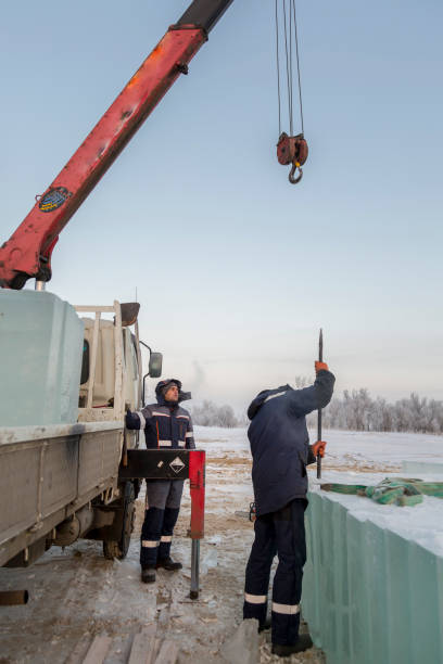 istock An assembly worker tries to push the ice slabs apart with a crowbar 1387413468