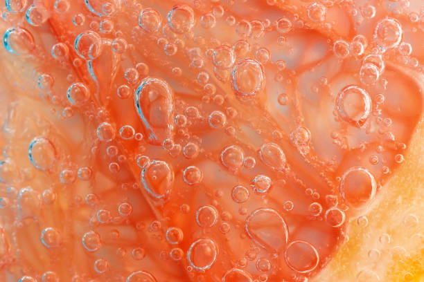 Grapefruit in the water under the water close-up macro. Selective focus. Background, fresh fruit