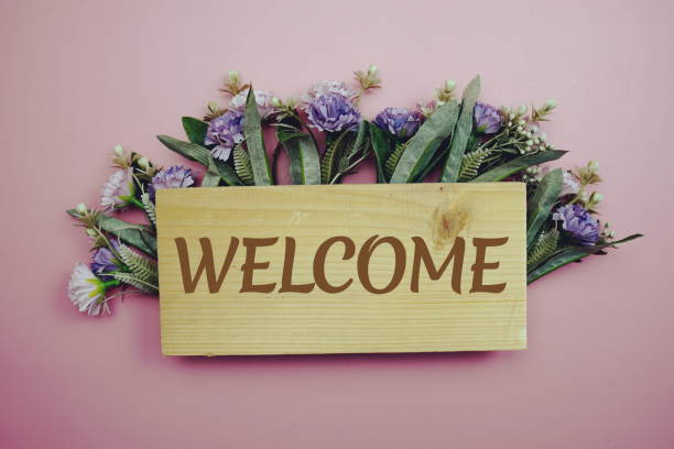istock Welcome Sign with flowers frame decprate on pink background 1387415088
