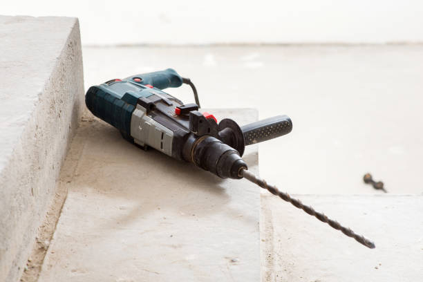 istock Construction hammer drill on a concrete staircase, during the construction of a house 1387415968