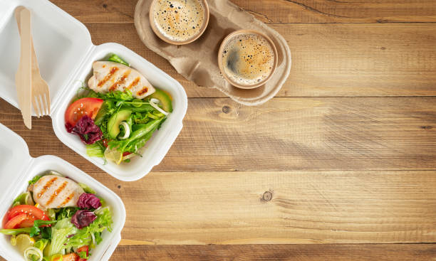 istock Lunch boxes with salad, grilled chichen and coffee on wooden table. Copy space, top view. 1387416356