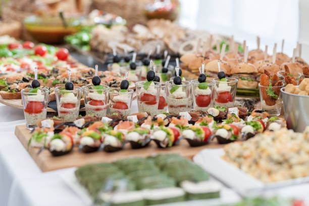 Wedding Table With Food. Snacks and Appetizer on the Table. Fish and Raw Meat with Vegetables. Mini Burgers