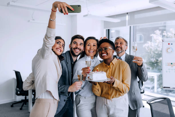 istock Happy friends talking a selfie in the office 1387418265