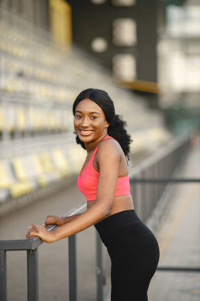 istock Indian girl doing excercises on a stadium 1387418711