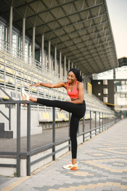 istock Indian girl doing excercises on a stadium 1387419252