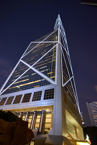Directly below view of Bank of China Tower postmodern architecture by night, Hong Kong island most recognizable landmark.