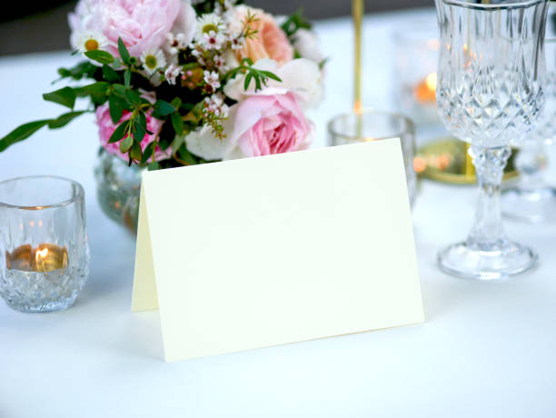 istock Mockup white blank space card, for Name place, greeting, invitation on wedding table setting background. with clipping path 1387419456