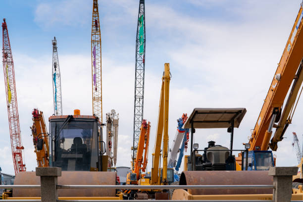 JCB crane loading the truck outdoor near construction site.