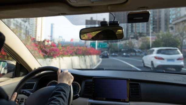 istock People driving car on city road 1387420655