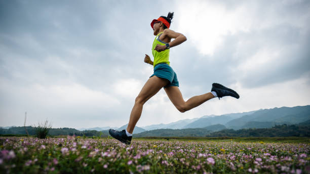 Female runner running in spring stock photo