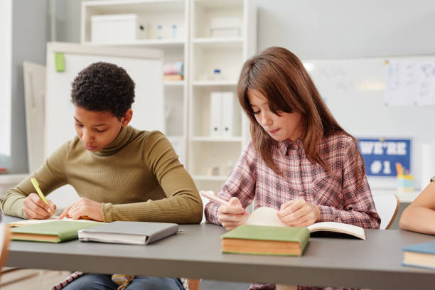 istock Girls Taking Test in School 1387422048