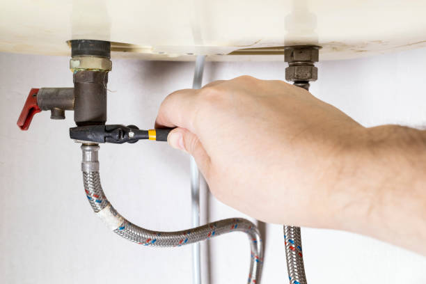 istock hand fixes valve by adjustable wrench on boiler 1387423795
