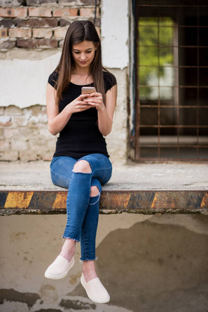istock Young woman with smart phone in spring 1387425031