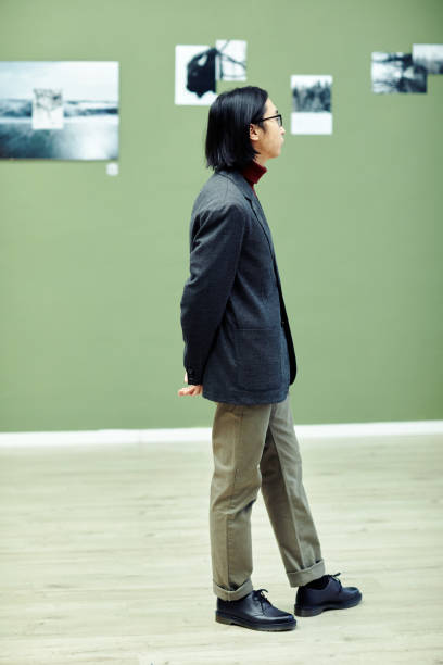 istock Young Asian Man Visiting Exhibition 1387425562