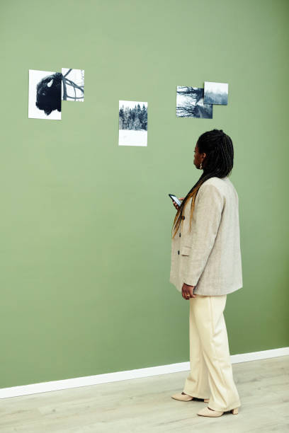 istock Stylish Black Woman Visiting Exhibition 1387425573