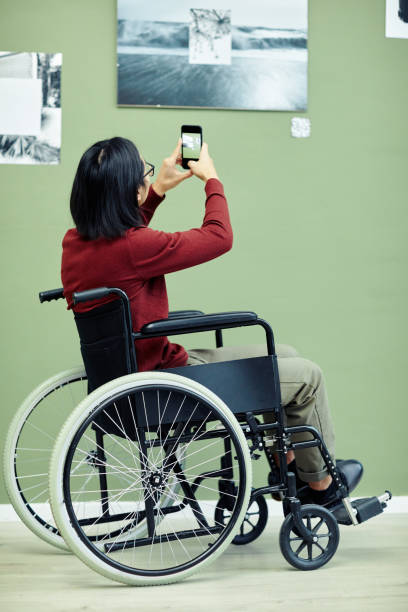 istock Man With Disability In Art Gallery 1387425625