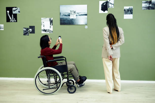 istock Two People At Photography Exhibition 1387425642