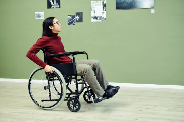 istock Asian Man With Disability Looking At Photos 1387425658