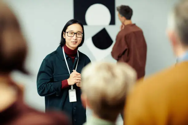 Photo of Young Man Giving Art Museum Tour