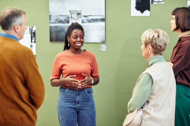 istock Young Photographer Talking To Visitors 1387425760