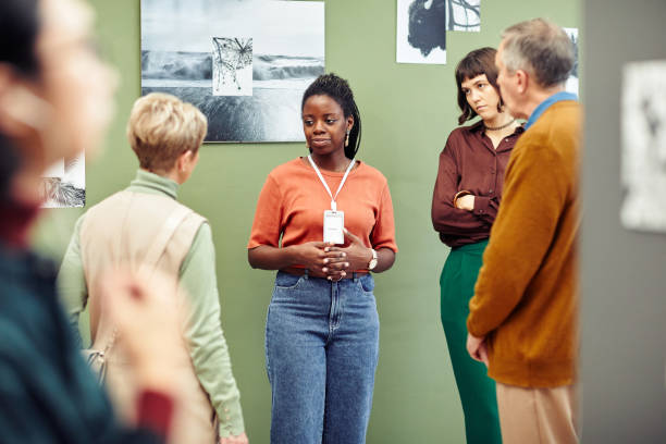Young Black Gallerist And Visitors