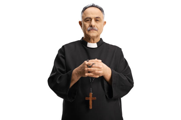 istock Mature priest holding prayer beads and looking at camera 1387428295
