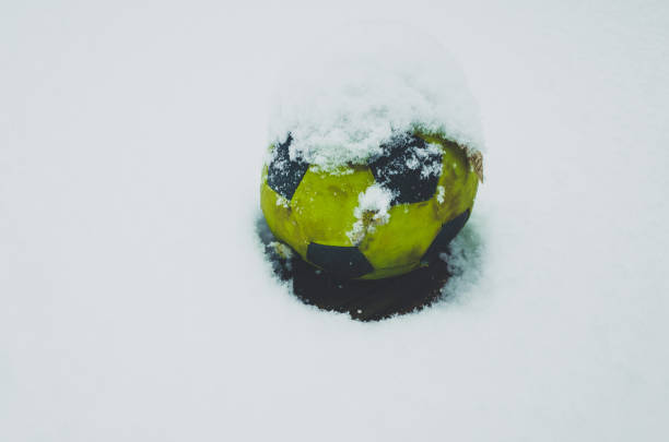 perfectly flat snowball in hands. Person Holding Snowball. Close-Up Of Cropped Hands Holding Snowball