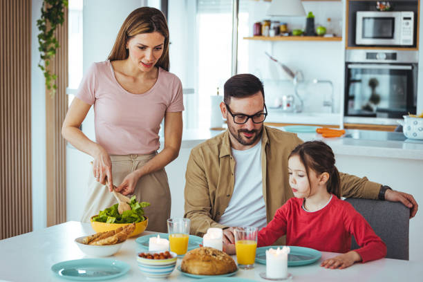 istock Happy family eating together in the kitchen. 1387433230