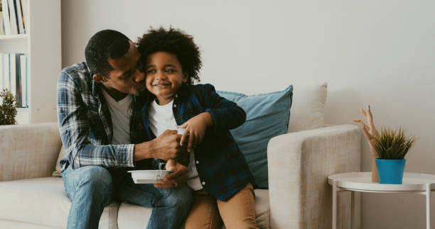 istock Father teaching energy saving to his son. Kissing. 1387434315