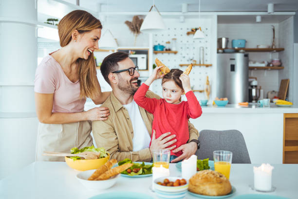 istock Mom, dad and daughter cook in the kitchen. 1387434510