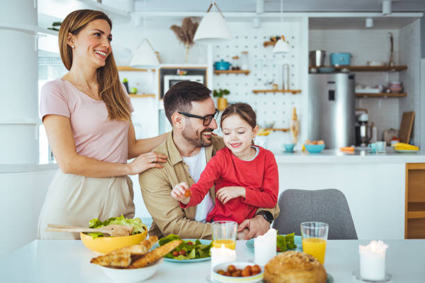 istock Mom, dad and daughter cook in the kitchen. 1387434516