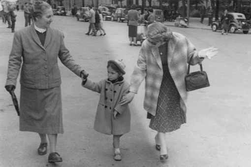 Family walking in a street, 1952.