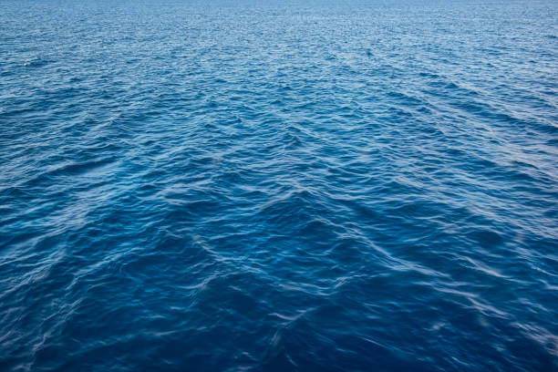 istock Deep blue aqua sea water surface in perespective texture background 1387440557
