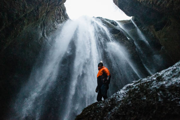 istock The man standing against the Gljufrabui Waterfall in Iceland 1387441009