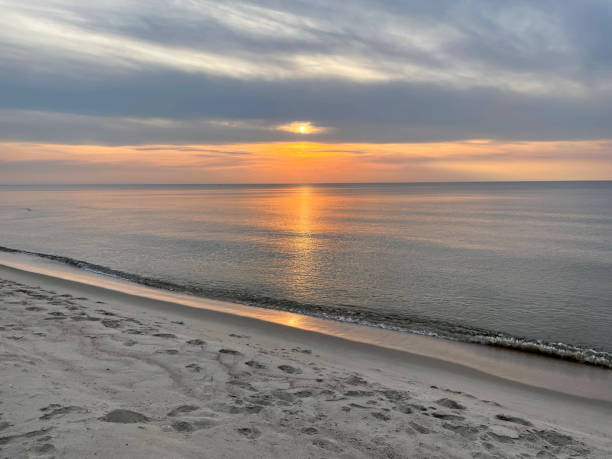 istock Beautiful sunset at sea seen from a beach 1387443831